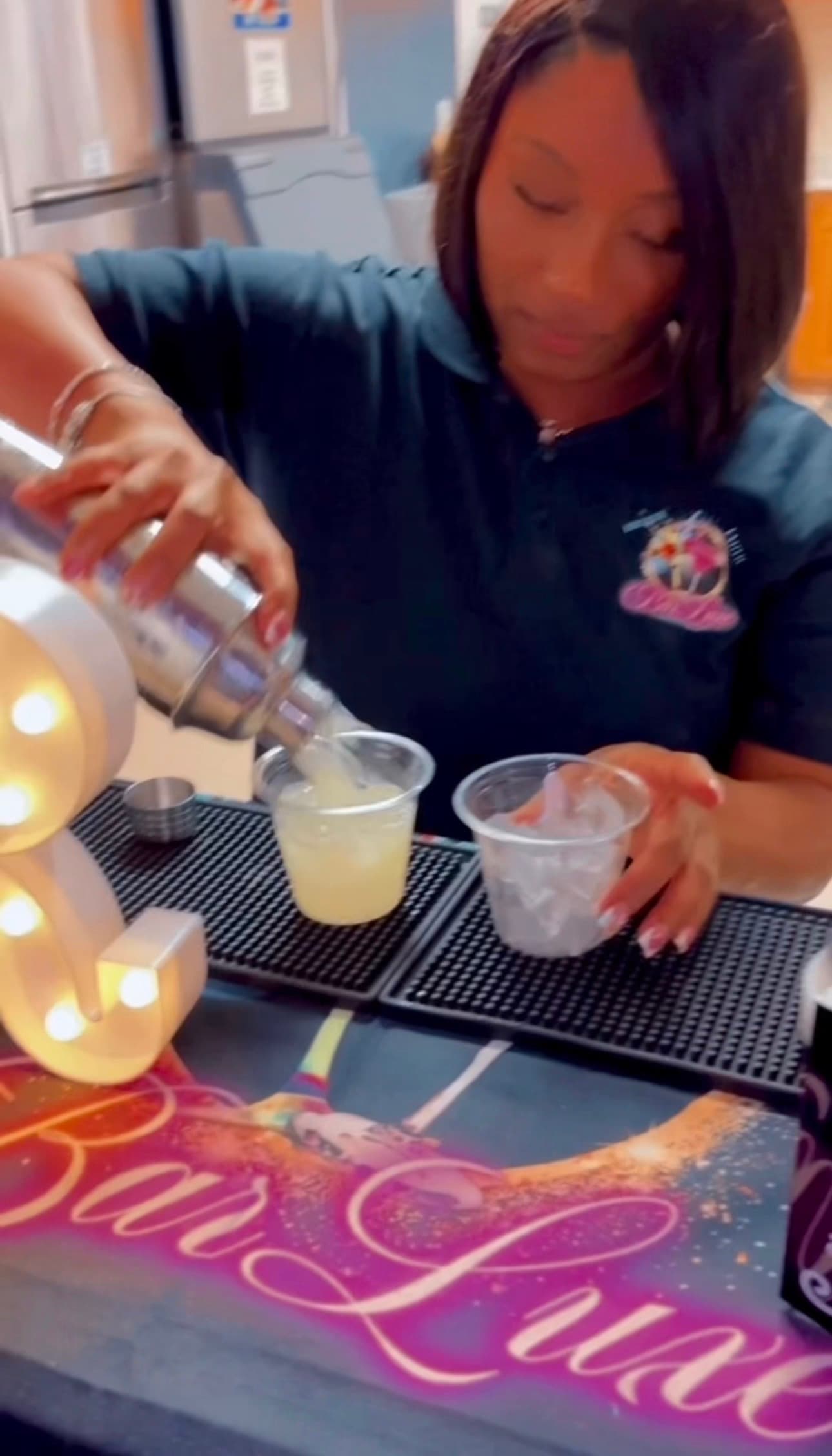 BigCee crafting a cocktail behind the BarLuxe bar