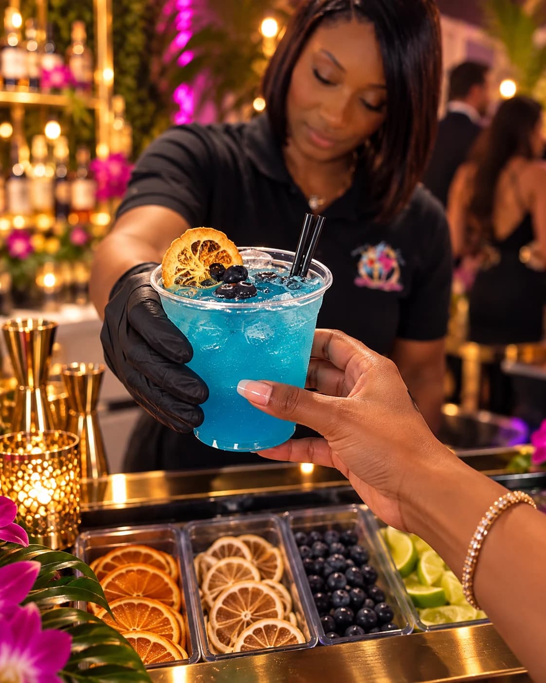 BigCee serving a blue cocktail to a guest